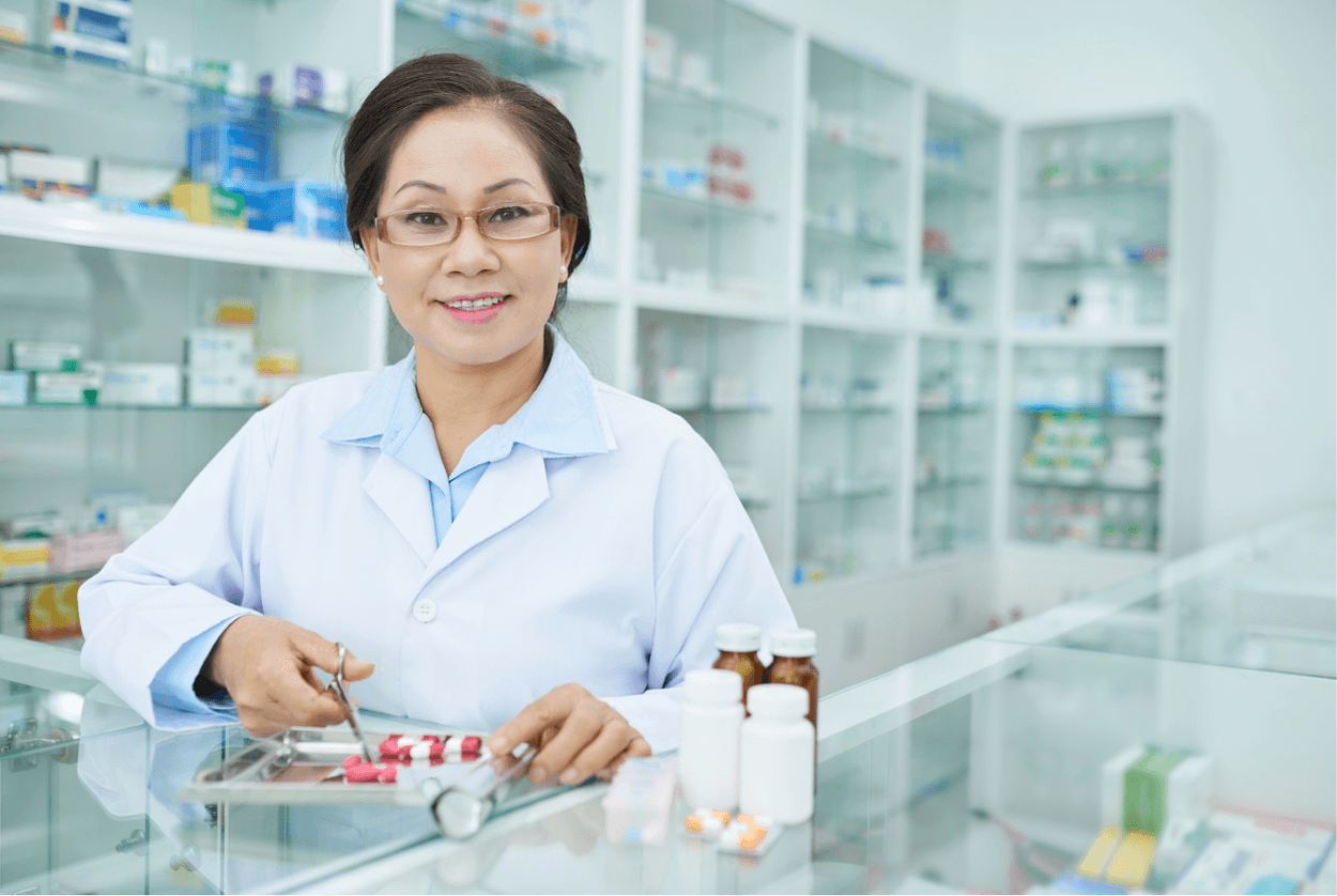 Pharmacist with various medication supplies